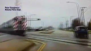 Dashcam video shows officer nearly get hit by train