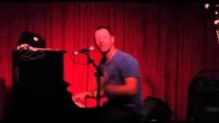 Coldplay s Chris Martin thanks applauding fans as he sits down to his piano and begin