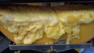 STREET FOOD, BOROUGH MARKET, RACLETTE - MELTED CHEESE POURED OVER BOILED POTATOES WITH PICKLES