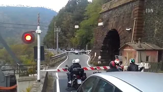 Train passing through tunnel and crossing road