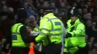 Funny Liverpool fan joins Suarez on pitch.