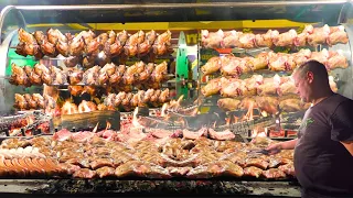 German Street Food. Rotating Machine Roasts Tons of Pork Knuckles, Ribs, Jumbo Sausages & more