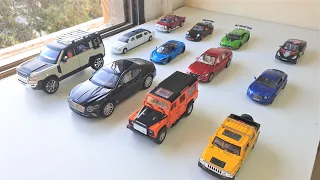 Bigger and Smaller Die cast Cars Driven by Hand on Windowsill