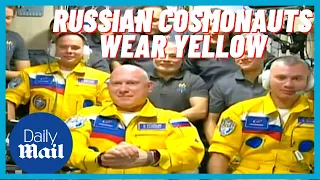 Russian cosmonauts in UKRAINIAN flag colours as they arrive on ISS