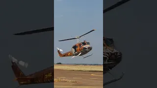 Huey painted in tiger stripes landing at Airshow in South Africa