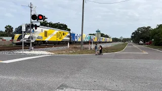 Brightline and Freight train cross paths — Railroad Crossing Gate — Micco + Barefoot Bay, FL