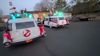 2 ghostbusters cars siren blaring Ecto 1 replicas