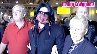 Michael Jackson Takes Off Running When Spotted By Paparazzi At Heathrow Airport In London, England