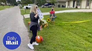 Woman protests outside of Brian Laundrie's family home