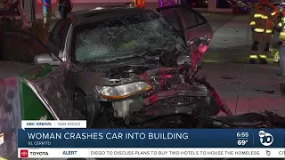 Woman taken to hospital after car crashes into building