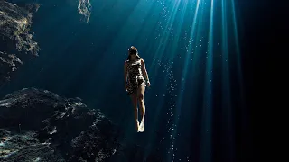 Freedive with light beams at Cenote El Pit (the Pit), Tulum Mexico