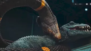 The giant snake wrapped around the tyrannosaurus, biting its neck and knocking it down!