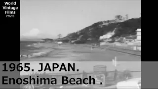 1965,JAPAN.Mt. Fuji seen from Enoshima coast. Neighborhood cityscape. Old car. Wooden building.