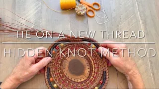 Hidden knot method to tie on a new thread