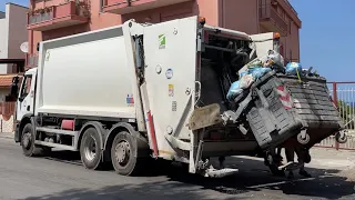 Rear Loader Garbage Truck on Overloaded Dumpsters in Italy