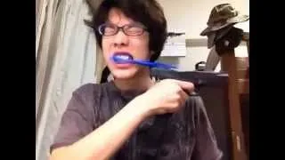 Guy brushes his teeth with an automatic pistol!