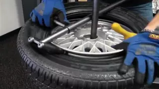 Change a car tire on a No-Mar scratch proof tire changer