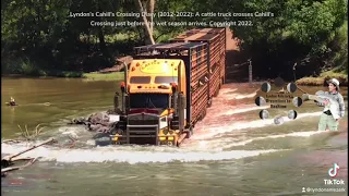 A Triple road train (truck) transports cattle over Cahills Crossing before the wet season arrives.