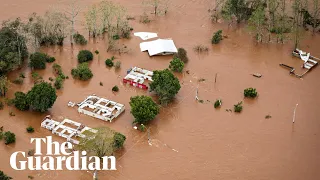 Floods submerge homes and leave at least 21 people dead in Brazil