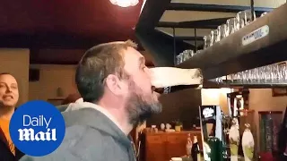 Man shows some serious skills at downing pint in amazing pub trick - Daily Mail