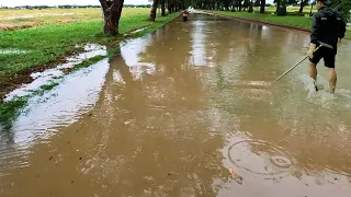 Going Outside Unclogged Drain After Storm Flooded Street