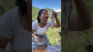 Asian girl eats a raw frog. Chinese food