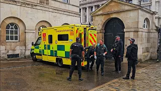 EMERGENCY AMBULANCE ARRIVES AT HORSE GUARDS on a rainy day... but it's not for the tourists!