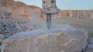 Hydraulic hammer breaking stone slow-motion