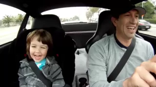 My boy laughing in the Porsche on the way to school..
