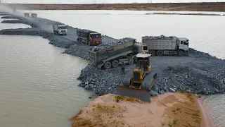 Team Dump Truck Work Transport Stone to Operator Bulldozer Push Stone Building Road Cross the water