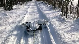 Homemade trail groomer with old pickup tires.