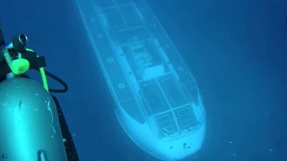 Submarine goes under diver