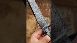 Mosaic damascus hunting knife with mammoth ivory handle.