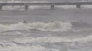 Raw: Surfers brave the waves as Tropical Storm Imelda lashes Galveston Island