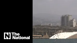 See Beirut blast site and sunken ship from port side