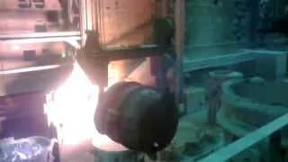 Pouring molten steel into water.