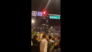 Fans Celebrate Denver Nuggets NBA Finals Win — One Doing Pull-Ups On Traffic Light Pole