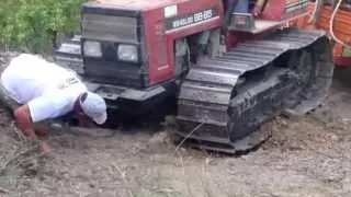 Tractor at work sliding to pull out logs form the bush