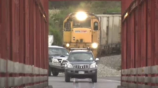 Train meets traffic on road - rail bridge in New Zealand