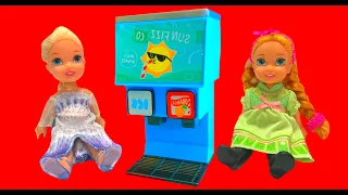 Elsa and Anna toddlers play with toy vending machines