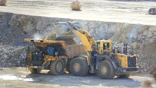 Komatsu WA800-3 loads CAT 777G's with limestone.