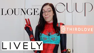 trying on bras in a Spiderman suit