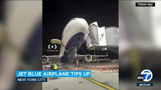 JetBlue plane tilts upward as passengers disembarking at JFK