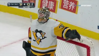 Brad Marchand punches goalie Tristan Jarry in the head.