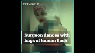 Plastic surgeon under fire for dancing with bags of human flesh