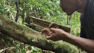 Making a fire with bamboo and wood friction.Fire Saw