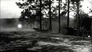 US Marine Artillery Battery firing 105mm howitzers. Buildings being destroyed by ...HD Stock Footage