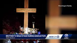 Boy walks across graduation stage in honor of late brother