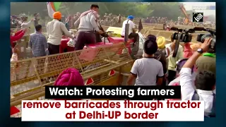 Watch: Protesting farmers remove barricades through tractor at Delhi-UP border