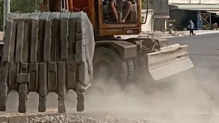 skilled excavator operator videos working on the road